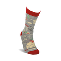 Lifestyle shot showing the Awesome Cookie Baker socks on a person's foot.  The socks are grey with red cuffs and a fun baking design.