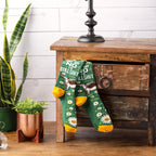 Lifestyle product shot showing 'Just Say No To Bullshit' socks casually displayed on a wooden side table. [lf]