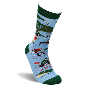 Single light blue crew sock with dark green trim. Design shows camping scenes, trees, a person chopping wood, and partial text 'R BE ING'.