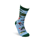 Single light blue crew sock with dark green trim. Design shows camping scenes, trees, a person chopping wood, and partial text 'R BE ING'.