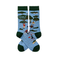 Pair of light blue crew socks with dark green trim. Features 'I'D RATHER BE CAMPING' text, trees, tents, and campers.