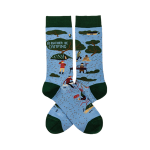 Pair of light blue crew socks with dark green trim. Features 'I'D RATHER BE CAMPING' text, trees, tents, and campers.