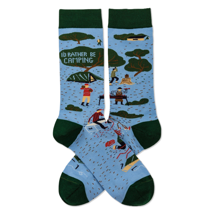 Pair of light blue crew socks with dark green trim. Features 'I'D RATHER BE CAMPING' text, trees, tents, and campers.