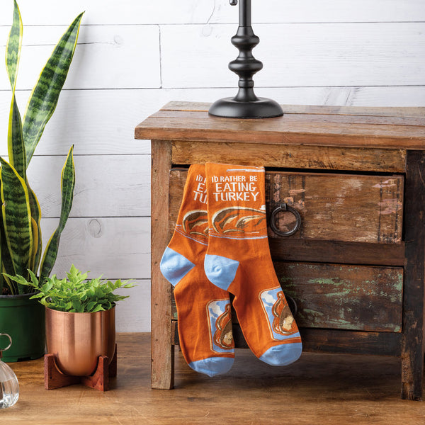 Lifestyle photo showing the socks casually placed on a wooden drawer in a home setting. [lf]