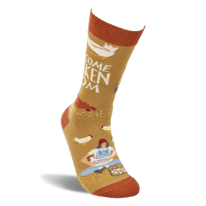 Single mustard yellow crew sock shown standing, with a woman gathering eggs and chickens visible on the design.