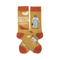 Pair of mustard yellow crew socks crossed, featuring a woman, chickens, eggs, and "Awesome Chicken Mom" text.