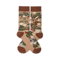 Two tan nature-themed crew socks crossed, showing a fox, rabbit, green leaves, red berries, mushrooms, and "I'D RATHER BE IN NATURE" text.