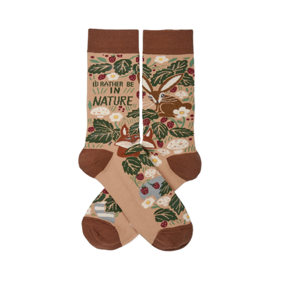 Two tan nature-themed crew socks crossed, showing a fox, rabbit, green leaves, red berries, mushrooms, and "I'D RATHER BE IN NATURE" text.