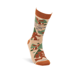 Single beige crew sock with rust orange cuff, heel, and toe. It features brown Sasquatch, green trees, and "I'd Rather Be Squatchin'" text.