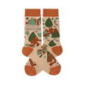 Pair of crew socks in beige, rust orange, and green, patterned with brown Sasquatch, trees, and "I'd Rather Be Squatchin'" text.