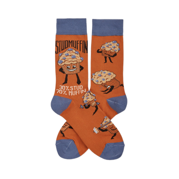 Pair of orange crew socks with blue cuffs, heels, and toes, featuring cartoon "Studmuffin" characters in various strong poses.