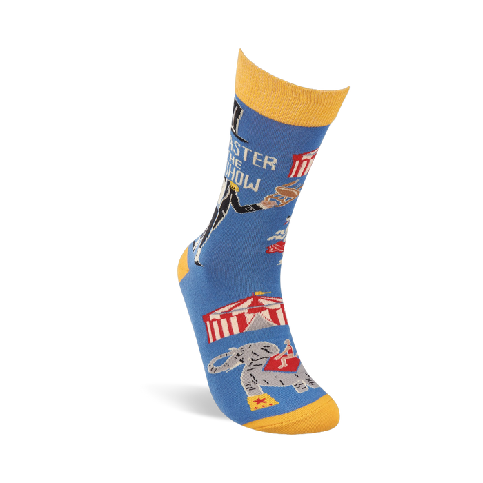 Single blue crew sock with yellow accents, angled. Shows ringmaster text, circus tent, balancing animal, and an elephant.