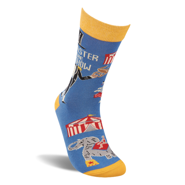 Single blue crew sock with yellow accents, angled. Shows ringmaster text, circus tent, balancing animal, and an elephant.