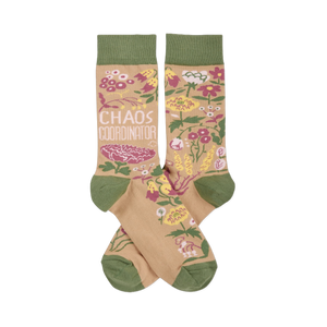 Pair of crew socks with tan background, olive green cuffs/heels/toes. Pink, yellow, white flowers & 'CHAOS COORDINATOR' text.