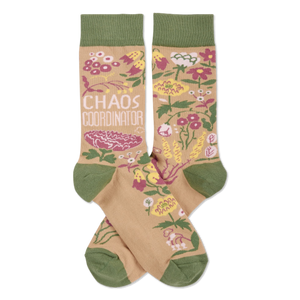 Pair of crew socks with tan background, olive green cuffs/heels/toes. Pink, yellow, white flowers & 'CHAOS COORDINATOR' text.