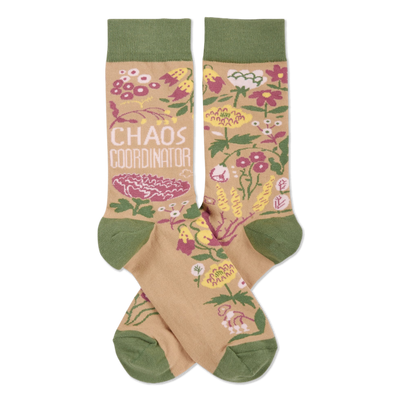 Pair of crew socks with tan background, olive green cuffs/heels/toes. Pink, yellow, white flowers & 'CHAOS COORDINATOR' text.