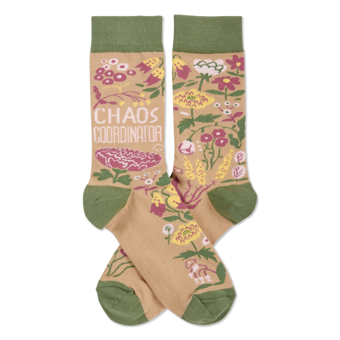 Pair of crew socks with tan background, olive green cuffs/heels/toes. Pink, yellow, white flowers & 'CHAOS COORDINATOR' text.