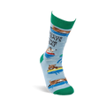 Single light blue crew sock with green heel, toe, and cuff, showing floating goats and "WHATEVER FLOATS YOUR GOAT" text.