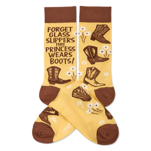 Pair of yellowish-tan crew socks with brown cuffs, heels, and toes. They feature brown cowboy boots, white flowers, and the quote 