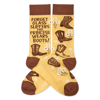Pair of yellowish-tan crew socks with brown cuffs, heels, and toes. They feature brown cowboy boots, white flowers, and the quote "FORGET GLASS SLIPPERS THIS PRINCESS WEARS BOOTS!" visible on one sock.