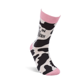 Single crew sock standing upright, showing black and white cow print with pink cuff, heel, and toe. "NOT IN THE MOOOOD!" text is visible on the leg.