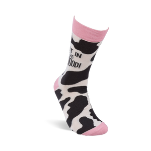 Single crew sock standing upright, showing black and white cow print with pink cuff, heel, and toe. 