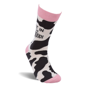 Single crew sock standing upright, showing black and white cow print with pink cuff, heel, and toe. 