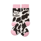 Pair of crew socks with black and white cow print, pink cuffs, heels, and toes. One sock reads "NOT IN THE MOOOOD!".