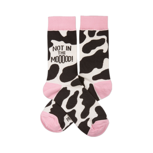 Pair of crew socks with black and white cow print, pink cuffs, heels, and toes. One sock reads 
