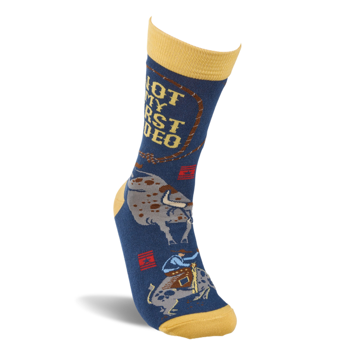 Single dark blue crew sock with yellow accents, shown upright, featuring 'NOT MY FIRST RODEO' text and a bucking bull.