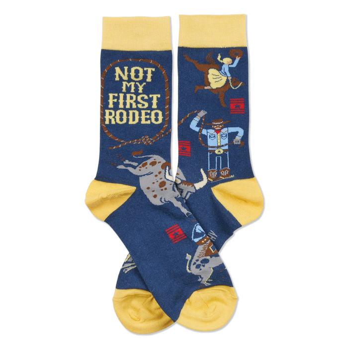 Pair of dark blue crew socks with yellow cuffs, heels, and toes. Design includes cowboys, bulls, and 