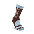 Single brown crew sock standing upright, showing "SAVING THE WORLD ONE DAD JOKE at a TIME" and "WHAT DO CLOUDS WEAR? THUNDERWEAR" in speech bubbles, with light blue cuff, heel, and toe.