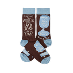 Pair of brown crew socks with light blue cuffs, heels, and toes. White text reads "SAVING THE WORLD ONE DAD JOKE at a TIME" and "WHERE DO SICK BOATS GO? the DOCK" inside speech bubbles.