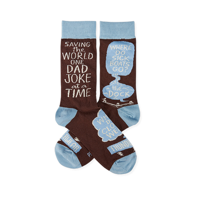 Pair of brown crew socks with light blue cuffs, heels, and toes. White text reads "SAVING THE WORLD ONE DAD JOKE at a TIME" and "WHERE DO SICK BOATS GO? the DOCK" inside speech bubbles.
