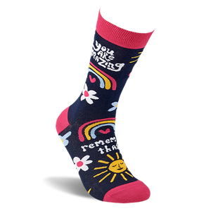 Single dark blue crew sock with pink accents, shaped to fit a foot, showing positive messages and cheerful patterns.