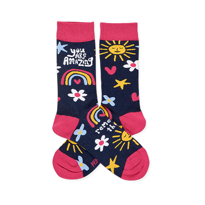 Pair of dark blue crew socks with pink cuffs, heels, toes. Features smiling suns, rainbows, flowers, stars, and 'YOU ARE AMAZING' text.