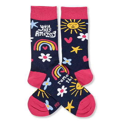 Pair of dark blue crew socks with pink cuffs, heels, toes. Features smiling suns, rainbows, flowers, stars, and 'YOU ARE AMAZING' text.