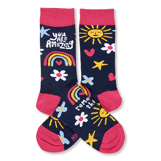 Pair of dark blue crew socks with pink cuffs, heels, toes. Features smiling suns, rainbows, flowers, stars, and 'YOU ARE AMAZING' text.