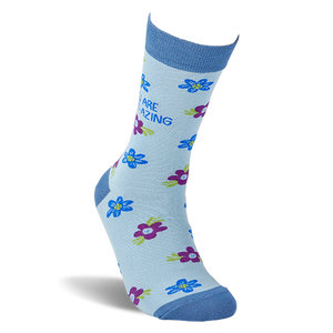 Single light blue crew sock on an invisible foot, covered in blue and purple flowers, with 