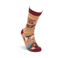 Single tan crew sock with reddish-brown accents, featuring horses, a barn, and 'I'd Rather Be At The Barn' text, angled upwards.