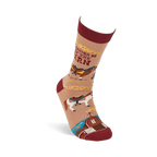 Single tan crew sock with reddish-brown accents, featuring horses, a barn, and 'I'd Rather Be At The Barn' text, angled upwards.