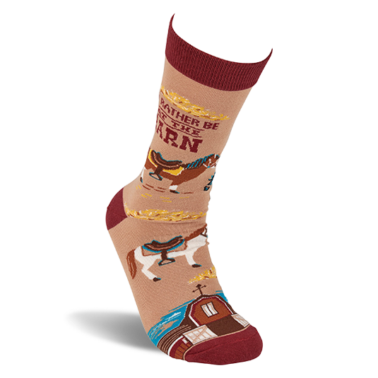 Single tan crew sock with reddish-brown accents, featuring horses, a barn, and 'I'd Rather Be At The Barn' text, angled upwards.