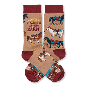 Pair of tan crew socks with reddish-brown cuffs, heels, and toes, featuring colorful horses, a barn, and 'I'd Rather Be At The Barn' text.
