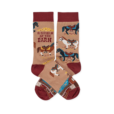 Pair of tan crew socks with reddish-brown cuffs, heels, and toes, featuring colorful horses, a barn, and 'I'd Rather Be At The Barn' text.