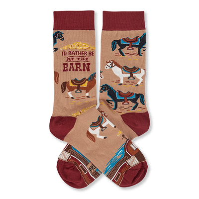 Pair of tan crew socks with reddish-brown cuffs, heels, and toes, featuring colorful horses, a barn, and 'I'd Rather Be At The Barn' text.