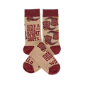 Pair of tan crew socks with maroon cuffs, heels, and toes, featuring a pattern of cowboy boots and an inspiring quote.