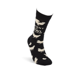 Single black crew sock with white chicken pattern and "Fluent In Fowl Language" text, viewed from the side, standing upright.