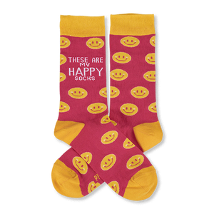 Pair of pink crew socks with yellow smiley faces. Yellow cuffs, heels, and toes. One sock features 'These Are My Happy Socks' text.