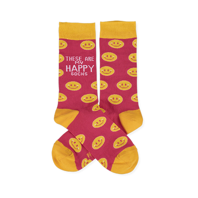 Pair of pink crew socks with yellow smiley faces. Yellow cuffs, heels, and toes. One sock features 'These Are My Happy Socks' text.