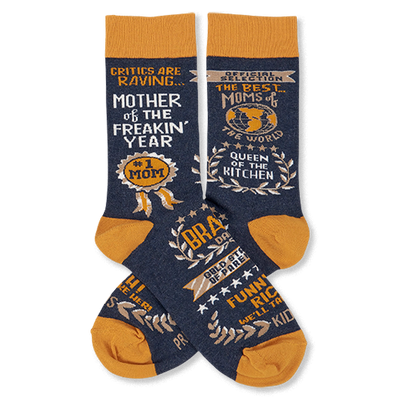 Pair of navy crew socks with orange cuffs, heels, and toes, featuring gold and white text graphics like 'Mother Of The Freakin' Year'.